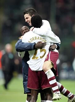 Cesc Fabregas celebrates with Emmanuel Eboue and Emmanuel Adebayor