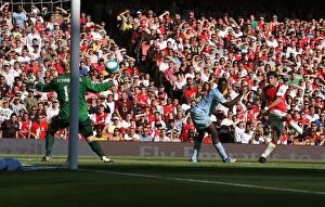 Arsenal v Manchester City 2007-08 Collection: Cesc Fabregas scores Arsenals goal past Micah Richards and Casper Schmeichel