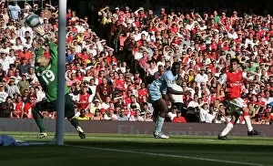 Arsenal v Manchester City 2007-08 Collection: Cesc Fabregas scores Arsenals goal past Micah Richards and Casper Schmeichel