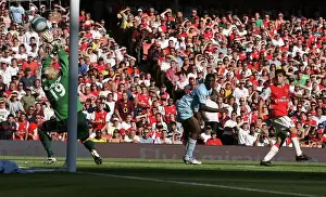 Cesc Fabregas scores Arsenals goal past Micah Richards and Casper Schmeichel