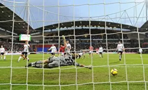 Cesc Fabregas shoots past Bolton goalkeeper Jussi Jaaskelainen to score the 1st Arsenal goal