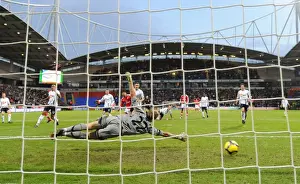 Cesc Fabregas shoots past Bolton goalkeeper Jussi Jskelainen to score the 1st Arsenal goal