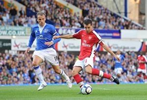 Everton v Arsenal 2009-10 Collection: Cesc Fabregas shoots past Phil Neville to score the 4th Arsenal goal