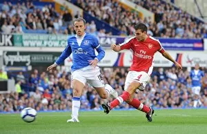 Images Dated 15th August 2009: Cesc Fabregas shoots past Phil Neville to score the 4th Arsenal goal