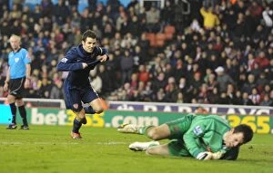 Images Dated 27th February 2010: Cesc Fabregas shoots past Stoke goalkeeper Thomas Sorensen to score the 2nd Arsenal goal