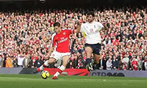 Cesc Fabregas shoots past Tottenham goalkeeper Heurelho