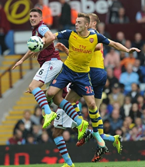 Aston Villa V Arsenal 2014-15 Prints: Chambers vs. Clark: Intense Battle in Aston Villa vs. Arsenal Premier League Clash