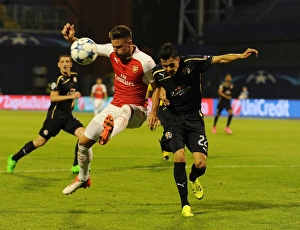 Champions Clash: Olivier Giroud vs. Leonardo Taravel - Arsenal's Star Forward Faces Off Against Dinamo Zagreb's Defender in the 2015-16 UEFA Champions League
