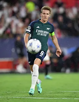 Sevilla V Arsenal 2023-24 Prints: Champions League Showdown: Odegaard Shines as Arsenal Takes on Sevilla