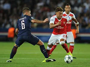 Paris Saint Gernain V Arsenal 2016-17 Prints: Champions League Showdown: Oxlade-Chamberlain vs