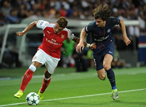 Paris Saint Gernain V Arsenal 2016-17 Prints: Champions League Showdown: Oxlade-Chamberlain vs
