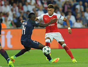 Paris Saint Gernain V Arsenal 2016-17 Prints: Champions League Showdown: Oxlade-Chamberlain vs