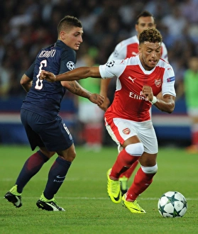 Paris Saint Gernain V Arsenal 2016-17 Prints: Champions League Showdown: Oxlade-Chamberlain vs