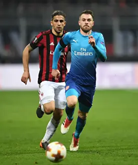 AC Milan V Arsenal 2017-18 Prints: Chasing the Ball: Ramsey vs. Rodriguez in the Europa League Showdown between AC Milan and Arsenal