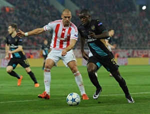 Olympiacos V Arsenal 2015-16 Prints: Clash in Athens: Campbell vs. Kasami - Olympiacos vs. Arsenal, UEFA Champions League