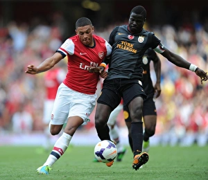 Arsenal V Galatasaray 2013-14 Prints: Clash of Champions: Oxlade-Chamberlain vs. Eboue - Arsenal vs. Galatasaray
