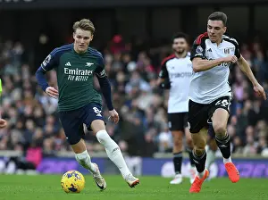 Clash at Craven Cottage: Arsenal's Martin Odegaard Fends Off Fulham's Joao Palhinha