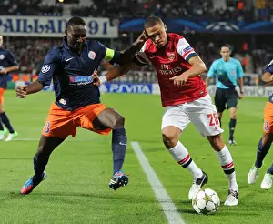 Montpellier V Arsenal 2012-13 Prints: Clash of Defenders: Gibbs vs. Yanga-Mbiwa - Montpellier vs