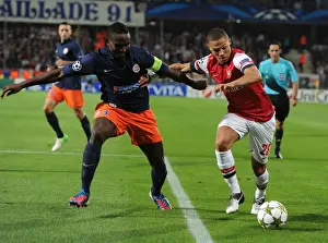 Montpellier V Arsenal 2012-13 Prints: Clash of Defenders: Gibbs vs. Yanga-Mbiwa - Montpellier vs