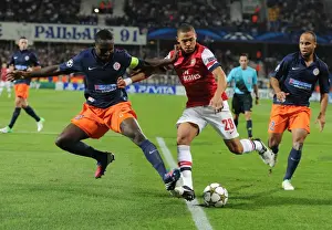 Montpellier V Arsenal 2012-13 Prints: Clash of Defenders: Gibbs vs. Yanga-Mbiwa - Montpellier vs