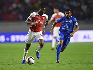 Al-Nasr Dubai SC V Arsenal 2018-19 Prints: Clash in Dubai: Al-Nasr vs. Arsenal - Maitland-Niles Faces Off Against Ali Hussain