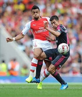 Arsenal v Benfica 2014-15 Collection: Clash at the Emirates: Coquelin vs. Gaitan