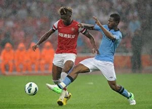 Images Dated 27th July 2012: Clash in the Far East: Alex Song vs Razak - Arsenal FC vs Manchester City, Beijing 2012