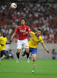 Uwara Red Diamonds V Arsenal 2013-14 Prints: Clash in Japan: Koscielny vs. Sakano - Urawa Red Diamonds vs. Arsenal (2013)