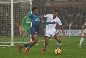 Swansea City V Arsenal 2017-18 Prints: Clash at Liberty: Iwobi vs. Naughton - A Football Rivalry Unfolds