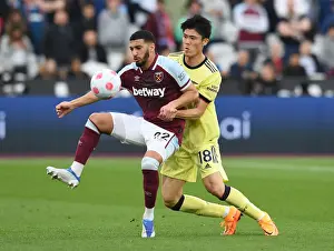 West Ham United V Arsenal 2021-22 Prints: Clash at London Stadium: Arsenal's Tomiyasu Faces Off Against West Ham's Benrahma