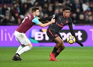 West Ham United v Arsenal 2017-18 Collection: Clash at London Stadium: Iwobi vs Cresswell in the Premier League Battle between West Ham