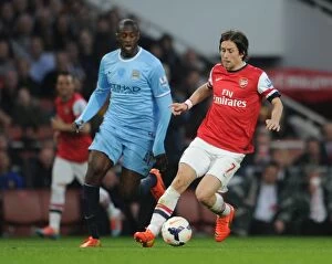Images Dated 29th March 2014: Clash of Midfield Giants: Rosicky vs. Yaya Toure (Arsenal vs. Manchester City, 2013/14)