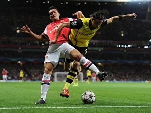 Arsenal v Borussia Dortmund 2013-14 Collection: Clash of the Midfield Maestros: Ozil vs. Hummels - Arsenal vs