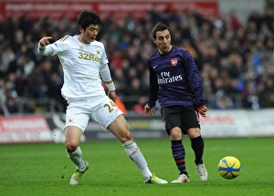 Swansea V Arsenal - FA Cup 3rd Rd 2012-13 Prints: Clash of Midfield Maestros: Santi Cazorla vs