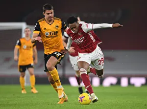 Clash of Midfield Titans: Joe Willock vs. Leander Dendoncker in Empty Emirates Stadium, Arsenal vs. Wolverhampton Wanderers, Premier League 2020-21
