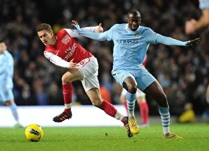 Images Dated 18th December 2011: Clash of Midfield Titans: Ramsey vs. Yaya Toure, Manchester City vs