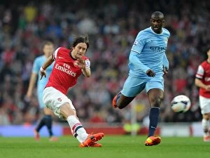 Images Dated 29th March 2014: Clash of Midfield Titans: Rosicky vs. Yaya Toure (Arsenal vs. Manchester City, 2013/14)