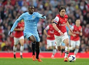 Images Dated 29th March 2014: Clash of Midfield Titans: Rosicky vs. Yaya Toure (Arsenal vs. Manchester City, 2013/14)