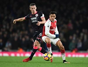 Arsenal v Huddersfield Town 2017-18 Collection: Clash of Midfield Titans: Sanchez vs Hogg - Arsenal's Premier League Showdown