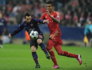 Bayern Munich V Arsenal 2012-13 Prints: Clash of Midfield Titans: Santi Cazorla vs