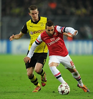 Borussia Dortmund V Arsenal 2013-14 Prints: Clash of Midfield Titans: Santi Cazorla vs
