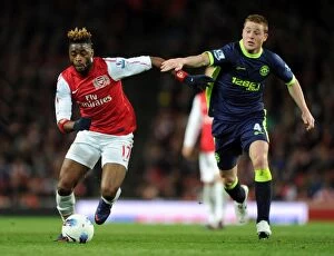 Images Dated 16th April 2012: Clash of Midfielders: Alex Song vs. James McCarthy - Arsenal v Wigan Athletic