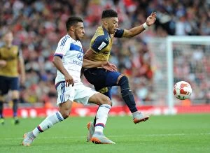 Arsenal v Olympique Lyonnais - Emirates Cup 2015/16 Collection: Clash of Midfielders: Oxlade-Chamberlain vs. Tolisso in Arsenal's Emirates Cup Match