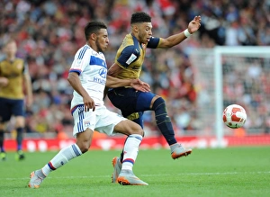 Arsenal V Olympique Lyonnais - Emirates Cup 2015/16 Prints: Clash of Midfielders: Oxlade-Chamberlain vs. Tolisso in Arsenal's Emirates Cup Match
