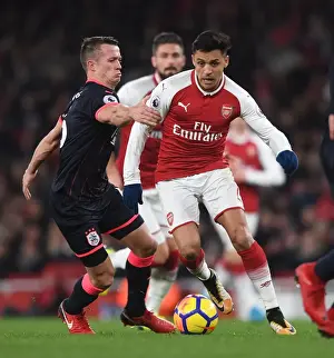 Arsenal V Huddersfield Town 2017-18 Prints: Clash of Midfielders: Sanchez vs Hogg in Arsenal's Battle Against Huddersfield