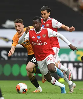 Wolverhampton Wanderers V Arsenal 2019-20 Prints: Clash at Molineux: Arsenal's Nketiah and Ceballos Battle Jota of Wolverhampton