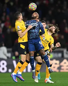 Wolverhampton Wanderers V Arsenal 2021-22 Prints: Clash at Molineux: Lacazette Faces Off Against Coady and Neves in Intense Wolverhampton Wanderers vs