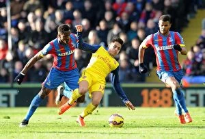 Images Dated 21st February 2015: Clash at Selhurst Park: Sanchez Fouls Zaha in Intense Crystal Palace vs. Arsenal Match