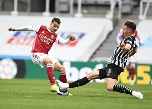 Newcastle United V Arsenal 2020-21 Prints: Clash at St. James Park: Arsenal's Martinelli Faces Off Against Newcastle's Schar in Empty Premier League Arena