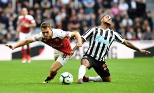 Images Dated 15th September 2018: Clash at St. James Park: A Duel Between Ramsey and Kenedy - Arsenal vs
